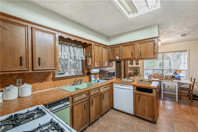 a kitchen with a sink stove top oven and cabinets