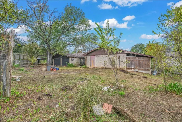 a house view with a backyard space