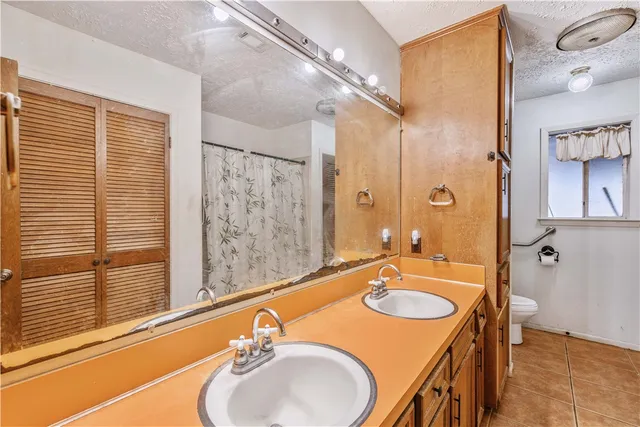 a bathroom with a sink double vanity and a mirror