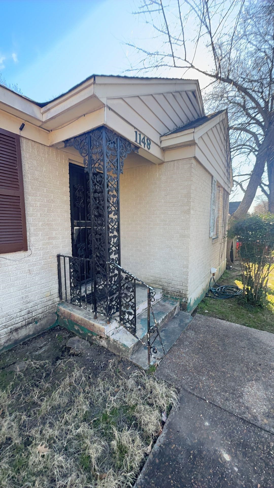 1148 Mt Vernon Road Memphis, TN 38111 - Photo 1 of 17 Brick exterior with a decorative wrought iron porch column and railing