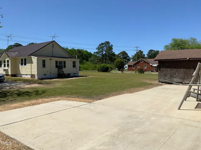 a living room with furniture a window and a flat screen tv