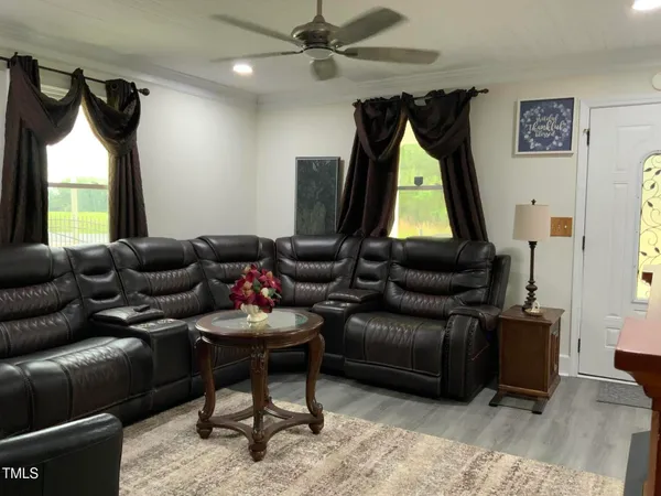 a living room with furniture a air conditioner and a window