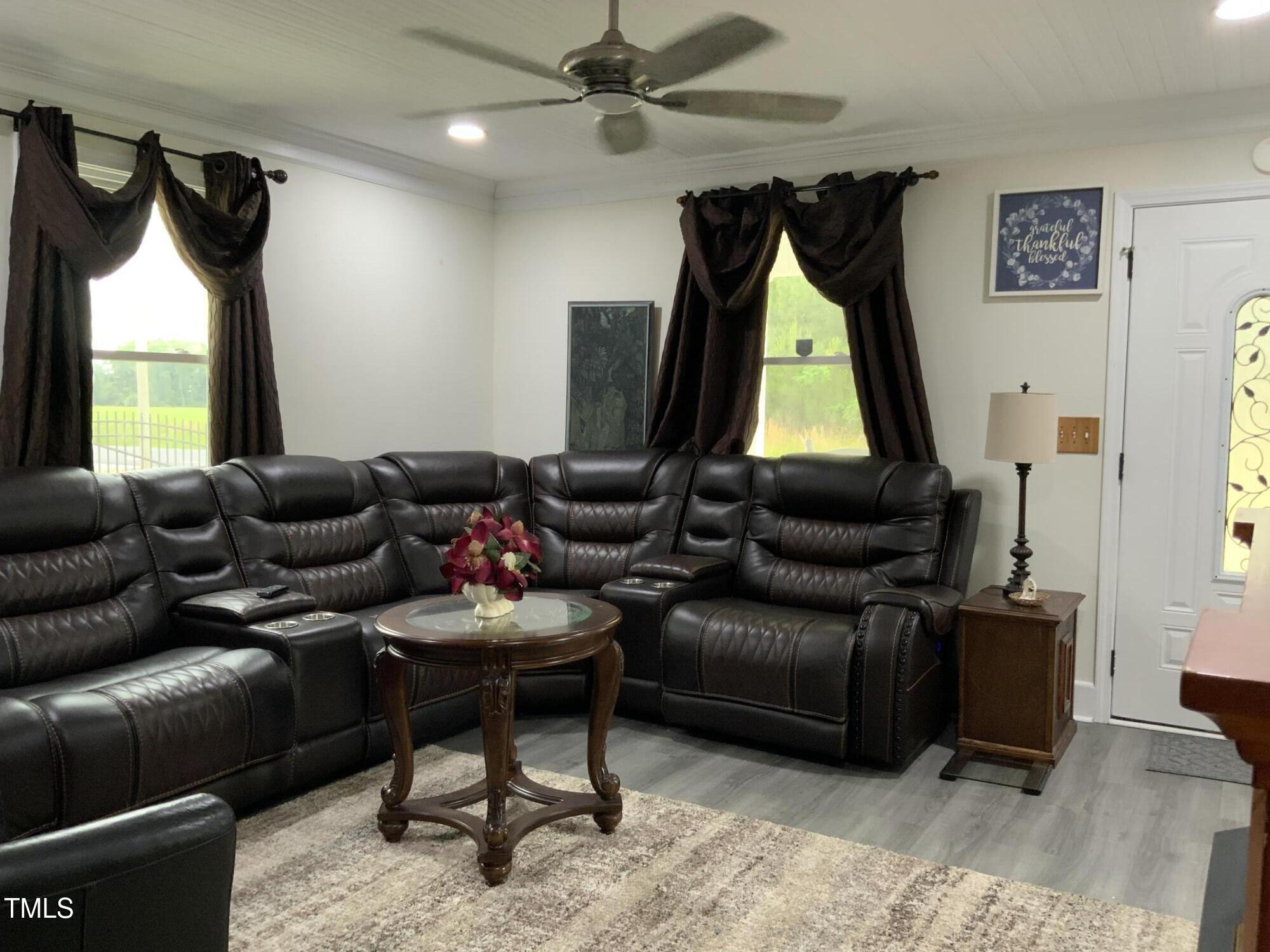 121 Storey Road Murfreesboro, NC 27855 - Photo 13 of 31 a living room with furniture a window and a flat screen tv