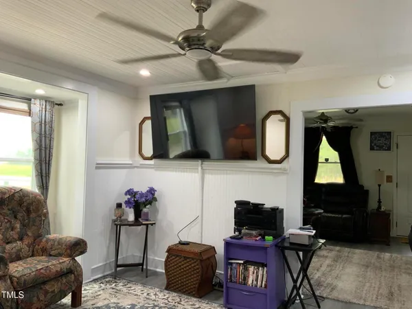 a bedroom with a bed and ceiling fan
