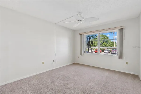 a spacious bedroom with a bed and a chandelier