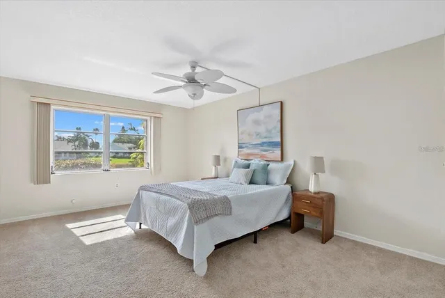 a spacious bedroom with a bed and a chandelier