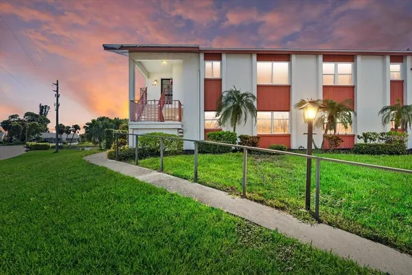 a front view of a house with a yard table and chairs