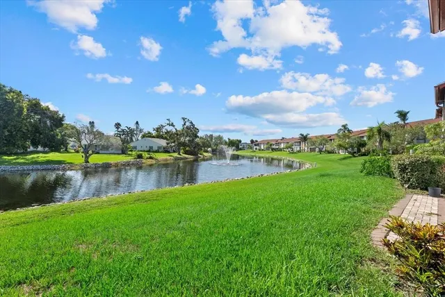 a view of a lake with houses in the back