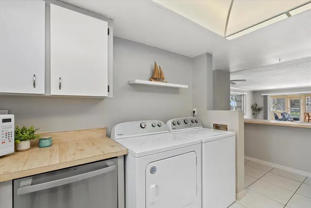 a utility room with sink dryer and washer