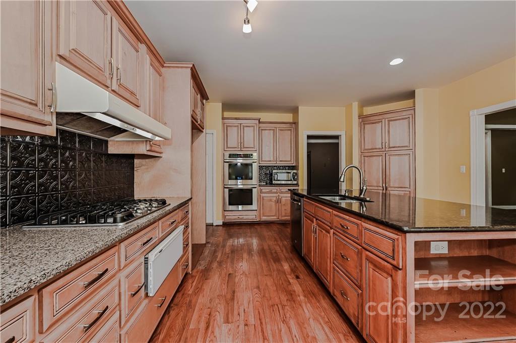 6430 Waters Edge Drive Midland, NC 28107 - Photo 18 of 48 a kitchen with stainless steel appliances a stove a sink and a refrigerator