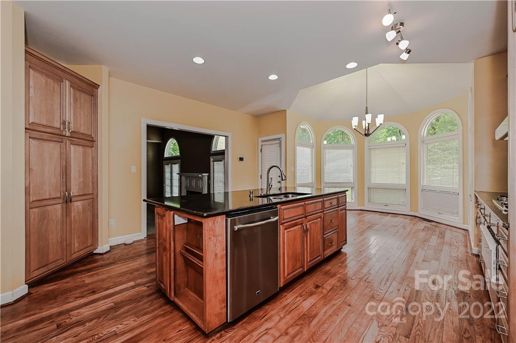 6430 Waters Edge Drive Midland, NC 28107 - Photo 19 of 48 a kitchen with stainless steel appliances granite countertop a stove and a refrigerator