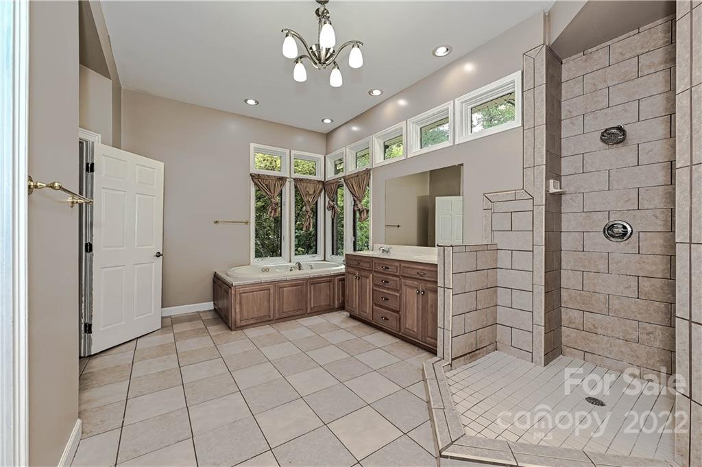6430 Waters Edge Drive Midland, NC 28107 - Photo 22 of 48 a bathroom with a tub shower vanity and sink