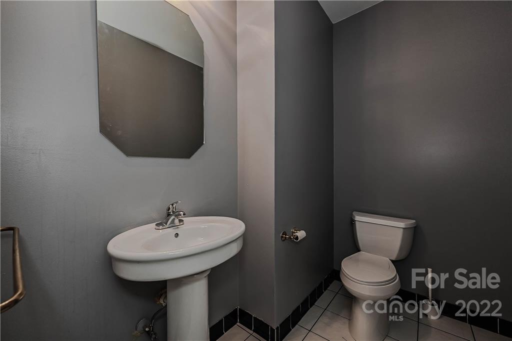 6430 Waters Edge Drive Midland, NC 28107 - Photo 25 of 48 a bathroom with a toilet a sink and mirror