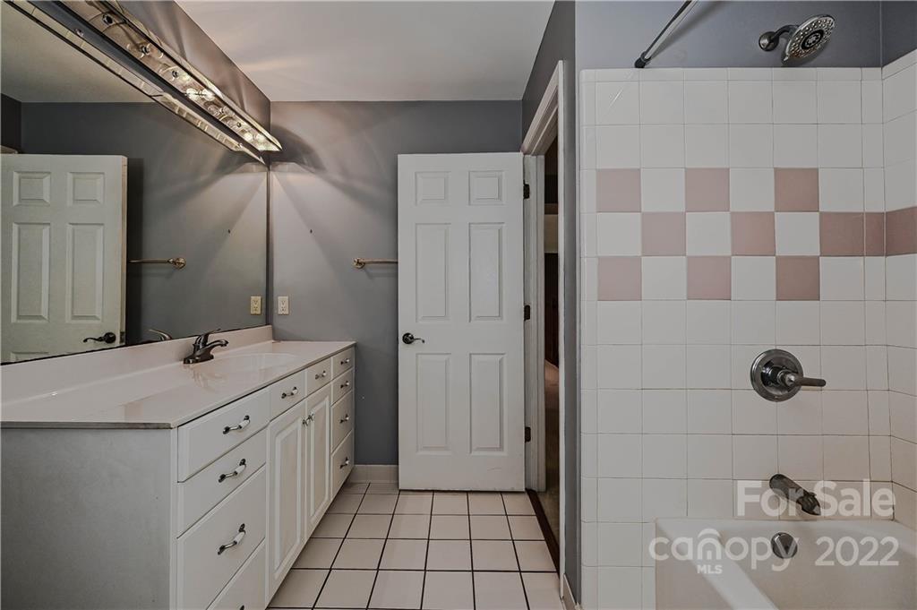6430 Waters Edge Drive Midland, NC 28107 - Photo 35 of 48 a bathroom with a double vanity sink a mirror and a shower