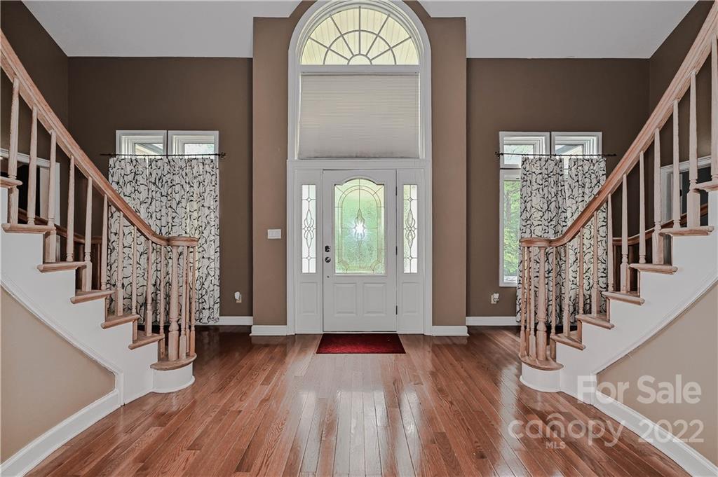 6430 Waters Edge Drive Midland, NC 28107 - Photo 4 of 48 a view of staircase with wooden floor and a chandelier
