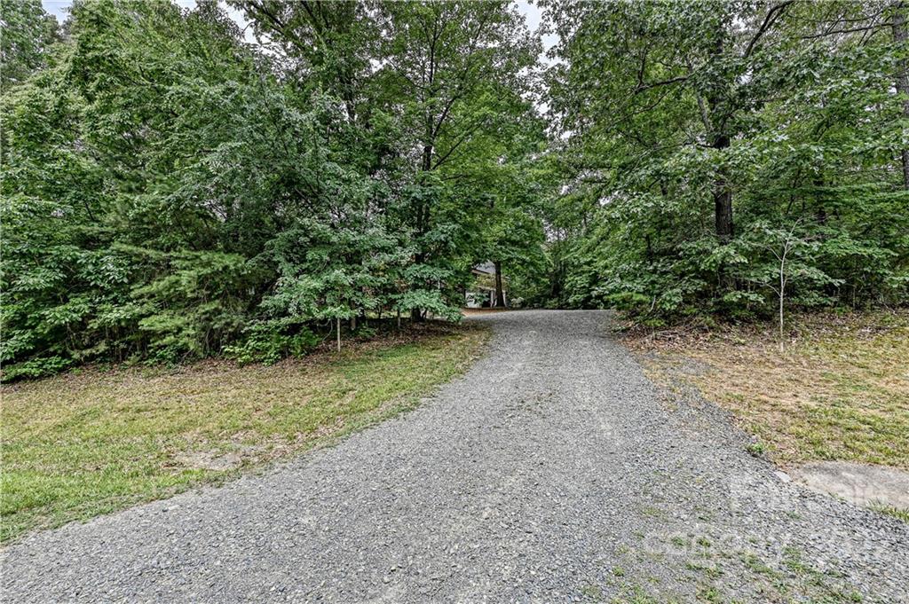 6430 Waters Edge Drive Midland, NC 28107 - Photo 46 of 48 a view of a green field with lots of bushes