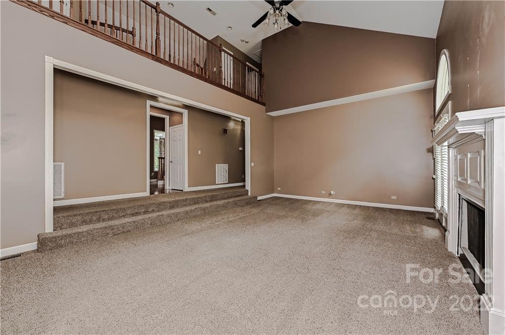 6430 Waters Edge Drive Midland, NC 28107 - Photo 9 of 48 a view of an empty room with a fireplace