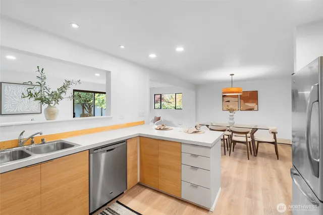 a kitchen with stainless steel appliances granite countertop a stove and a sink