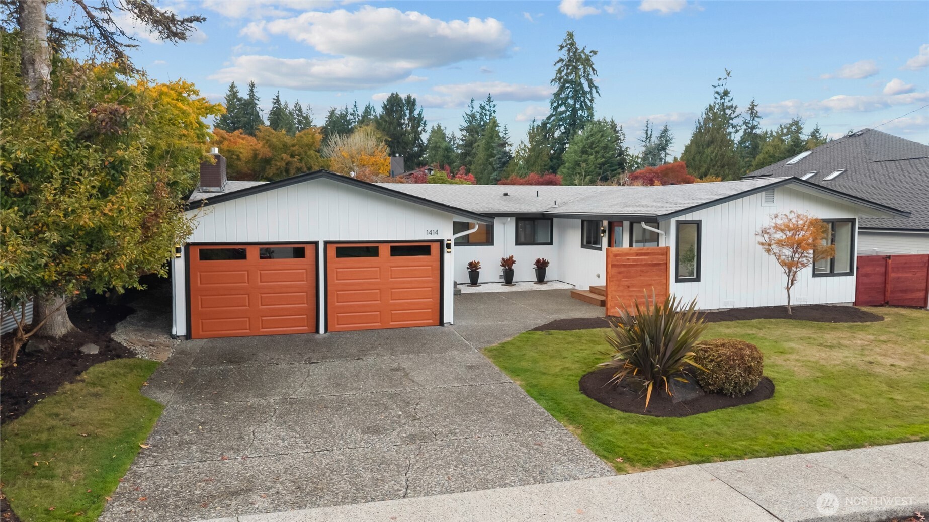 1414 Hummingbird Lane Northwest Olympia, WA 98502 - Photo 2 of 40 a front view of a house with a yard and garage