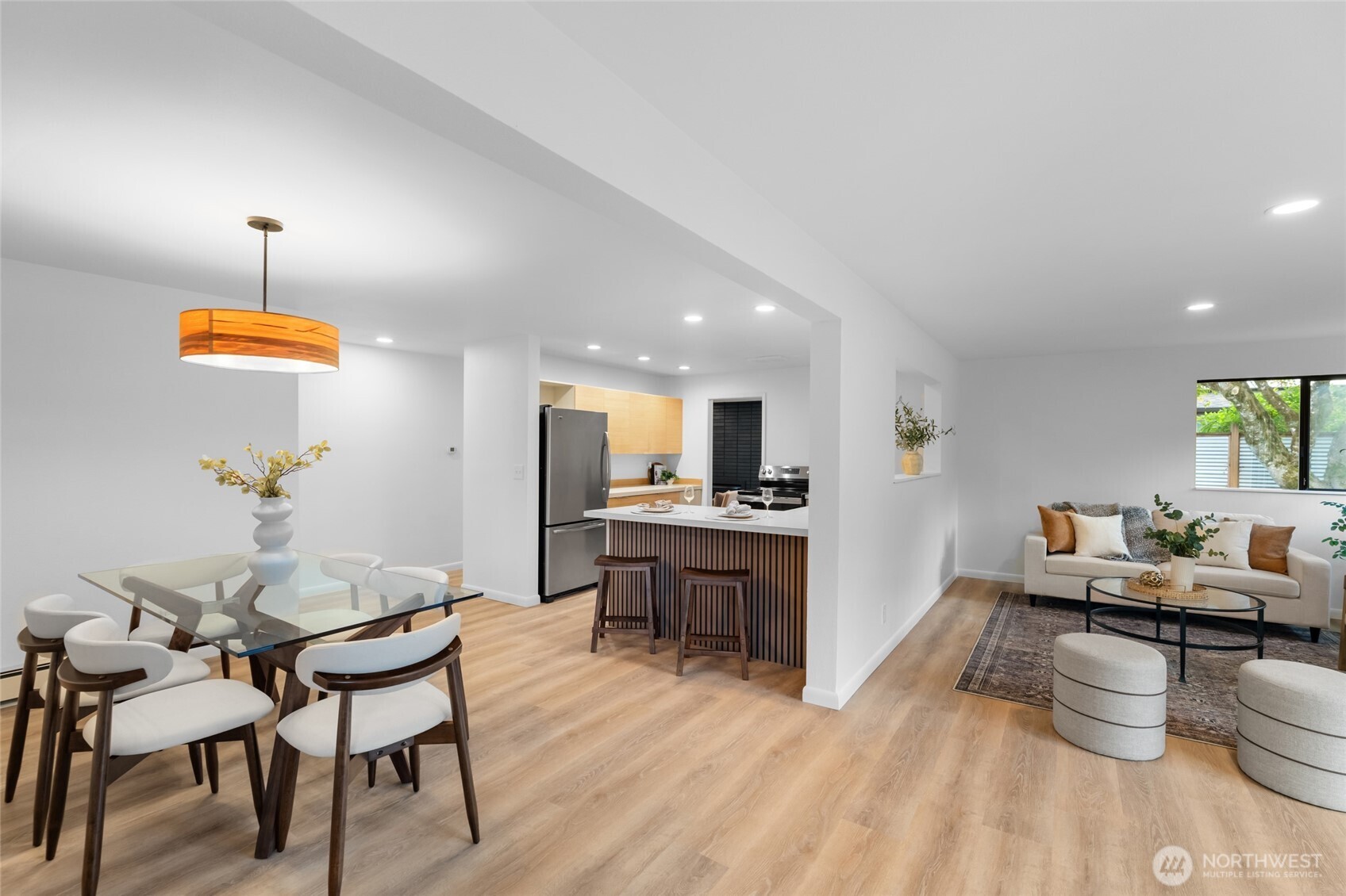 1414 Hummingbird Lane Northwest Olympia, WA 98502 - Photo 25 of 40 a living room with furniture kitchen view and a wooden floor