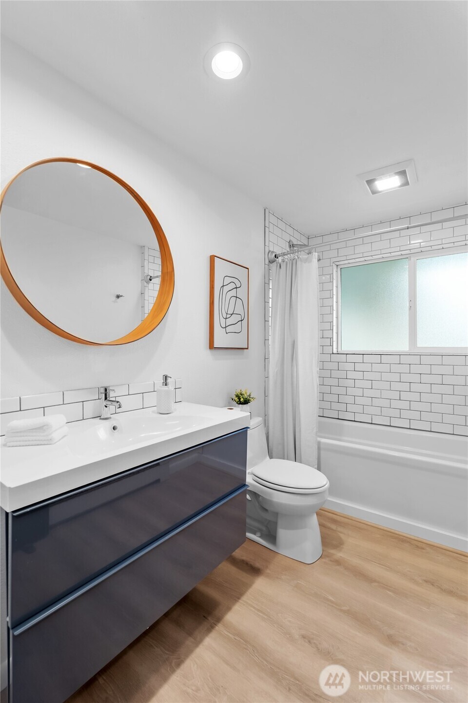 1414 Hummingbird Lane Northwest Olympia, WA 98502 - Photo 33 of 40 a bathroom with a double vanity sink toilet mirror and bathtub