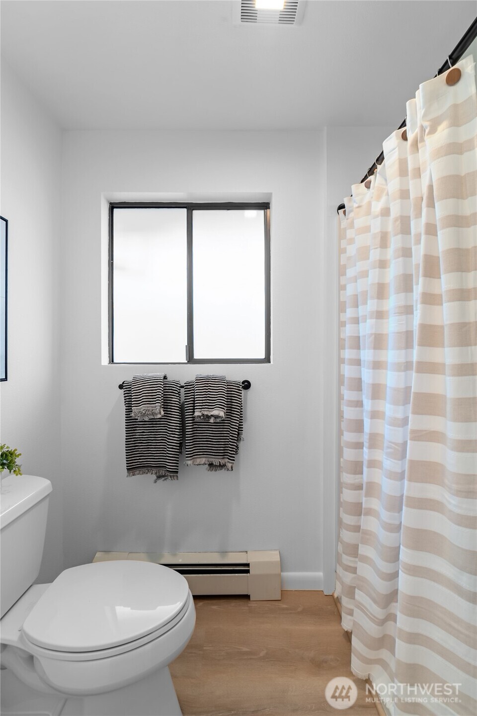 1414 Hummingbird Lane Northwest Olympia, WA 98502 - Photo 39 of 40 a bathroom with a toilet and a shower curtain