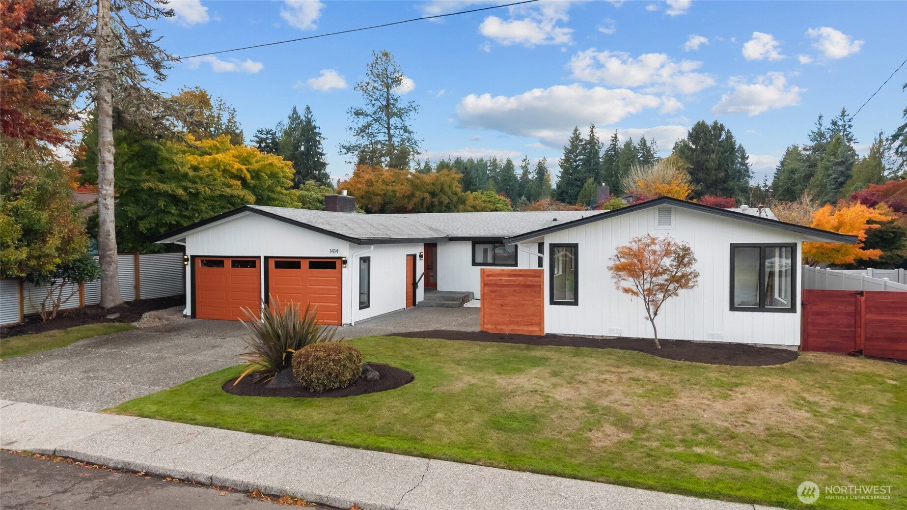 1414 Hummingbird Lane Northwest Olympia, WA 98502 - Photo 7 of 40 a front view of a house with a yard and garage
