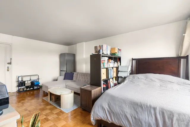 a bed room with a bed and a television