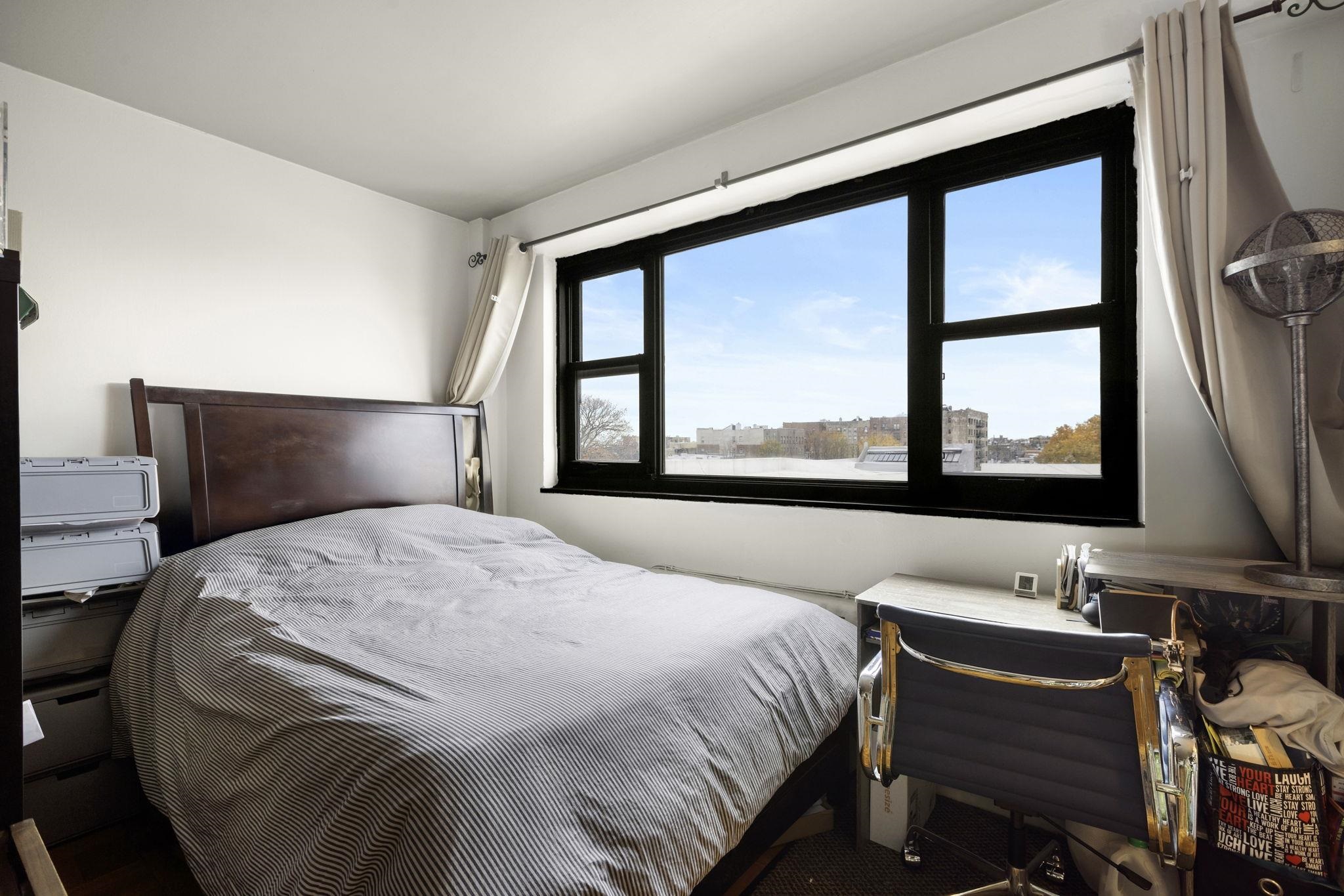 6515 Boulevard East, Unit 6R West New York, NJ 07093 - Photo 6 of 13 a bedroom with a bed and a large window with outer view