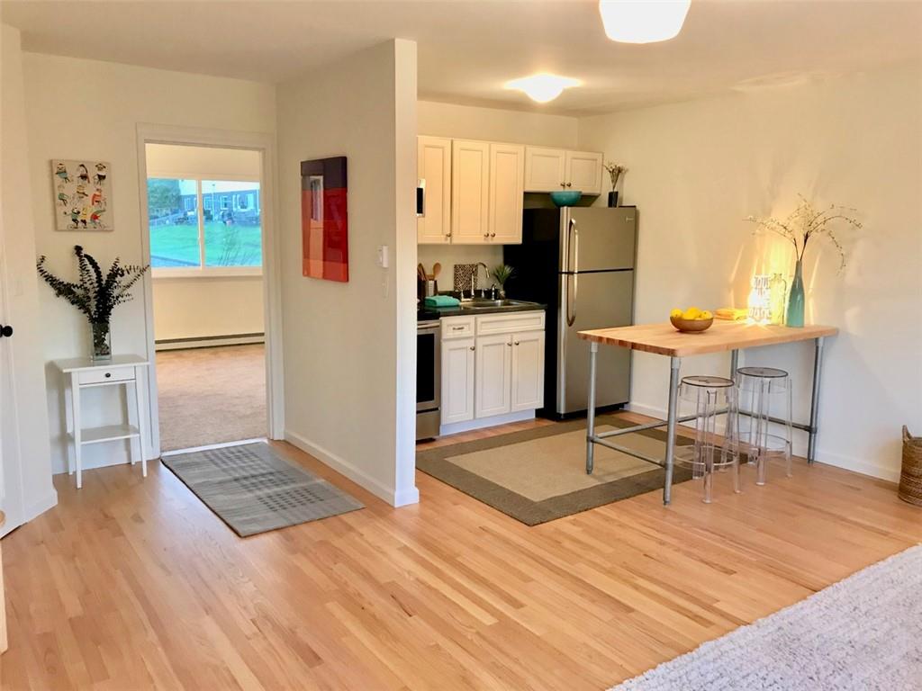 a kitchen with granite countertop a refrigerator and a stove top oven