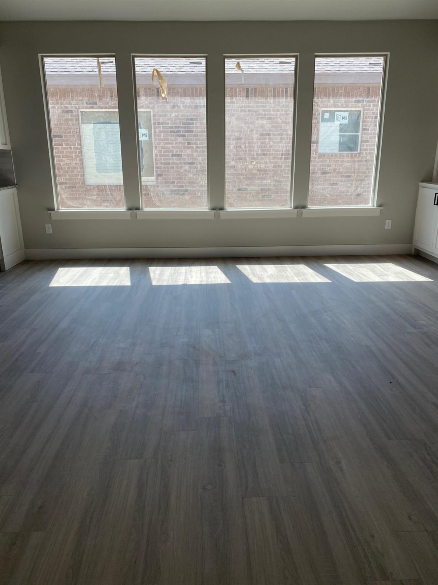 5845 Itasca Street Lubbock, TX 79416 - Photo 12 of 14 an empty room with wooden floor and windows