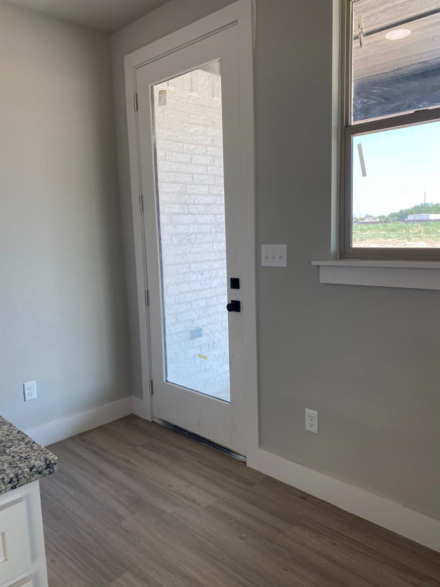 5845 Itasca Street Lubbock, TX 79416 - Photo 13 of 14 an empty room with wooden floor and windows