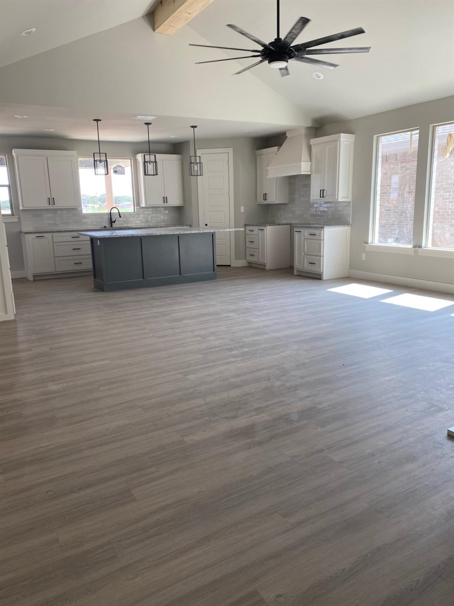 5845 Itasca Street Lubbock, TX 79416 - Photo 2 of 14 a large kitchen with stainless steel appliances a large counter top a sink and a chandelier