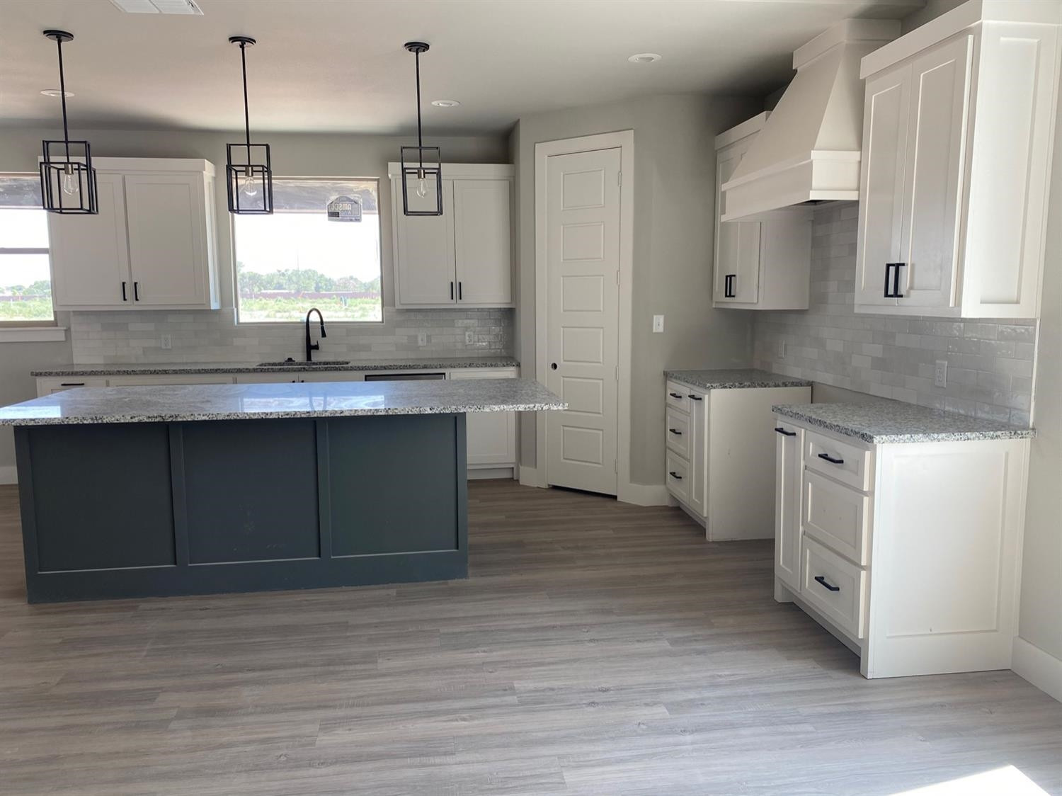 5845 Itasca Street Lubbock, TX 79416 - Photo 3 of 14 a kitchen with a sink cabinets and wooden floor