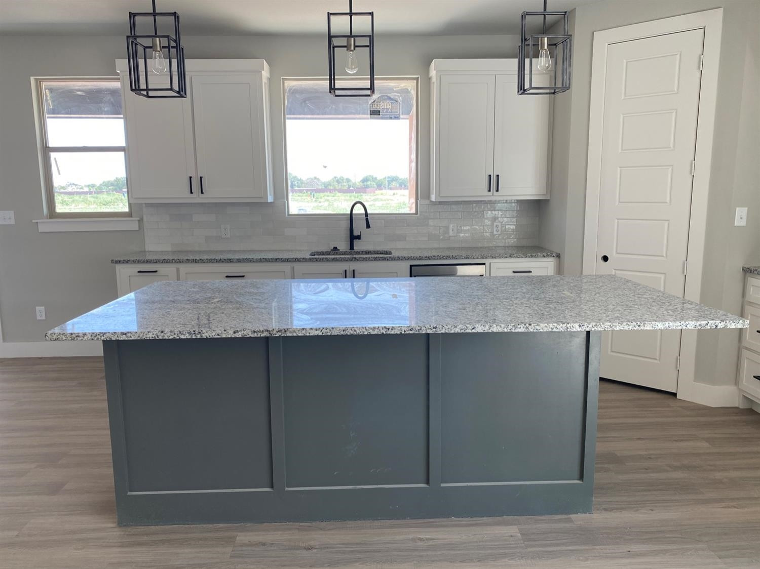 5845 Itasca Street Lubbock, TX 79416 - Photo 5 of 14 a kitchen with kitchen island granite countertop a sink cabinets and wooden floor