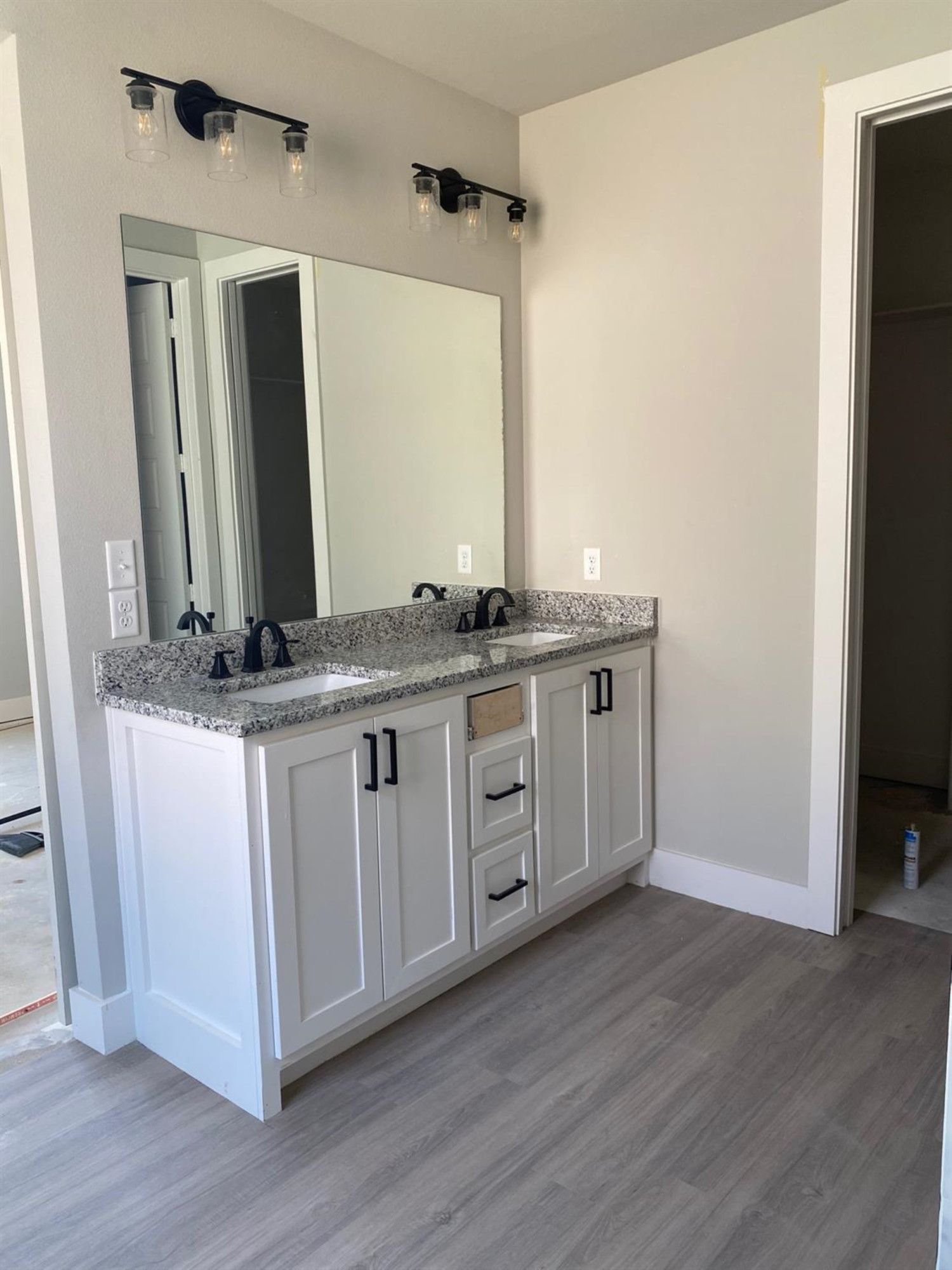 5845 Itasca Street Lubbock, TX 79416 - Photo 9 of 14 a bathroom with a granite countertop double vanity sink and mirror