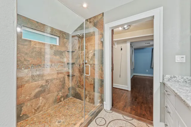 a bathroom with a granite countertop shower mirror and a sink