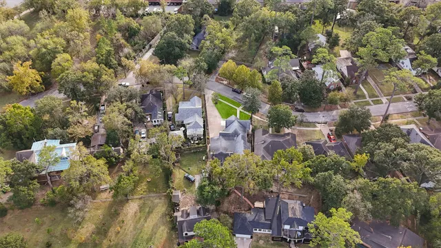an aerial view of a house with a yard and lake view