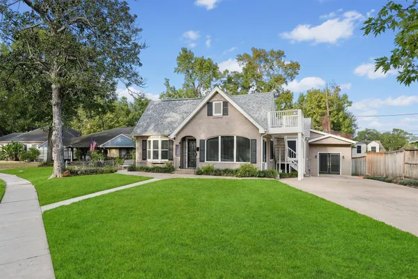 a front view of a house with a garden