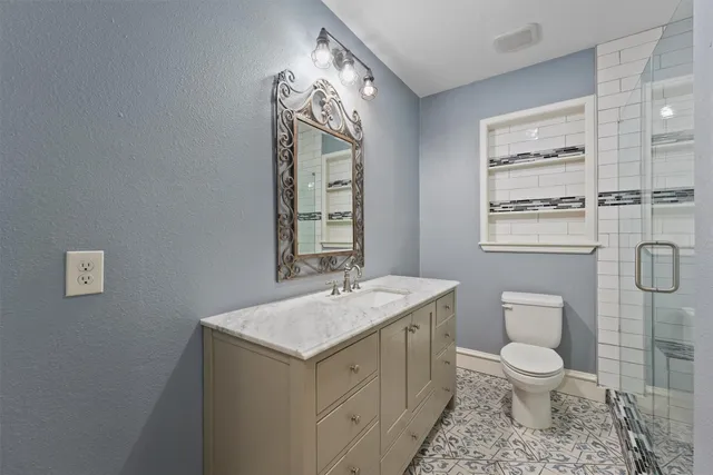 a bathroom with a toilet a sink and mirror