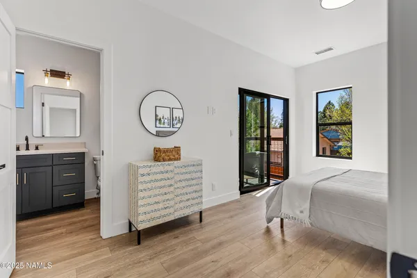 a bedroom with a bed a couch and dresser