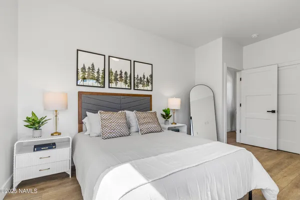 a bedroom with a bed and a potted plant