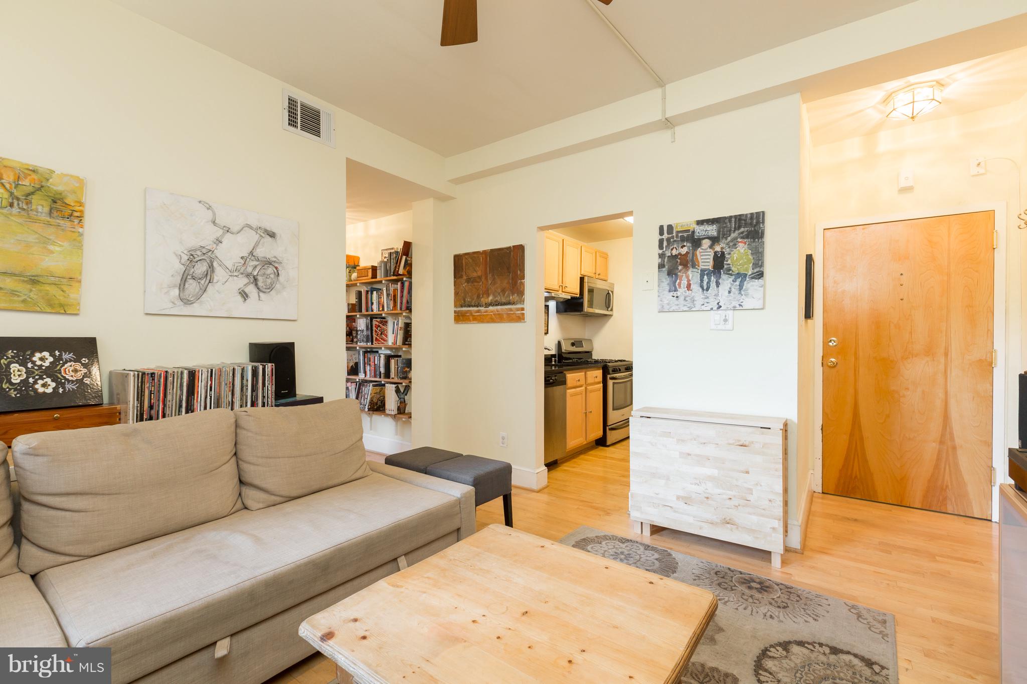 3060 16th Street Northwest, Unit 102 Washington, DC 20009 - Photo 3 of 17 a living room with furniture and a rug