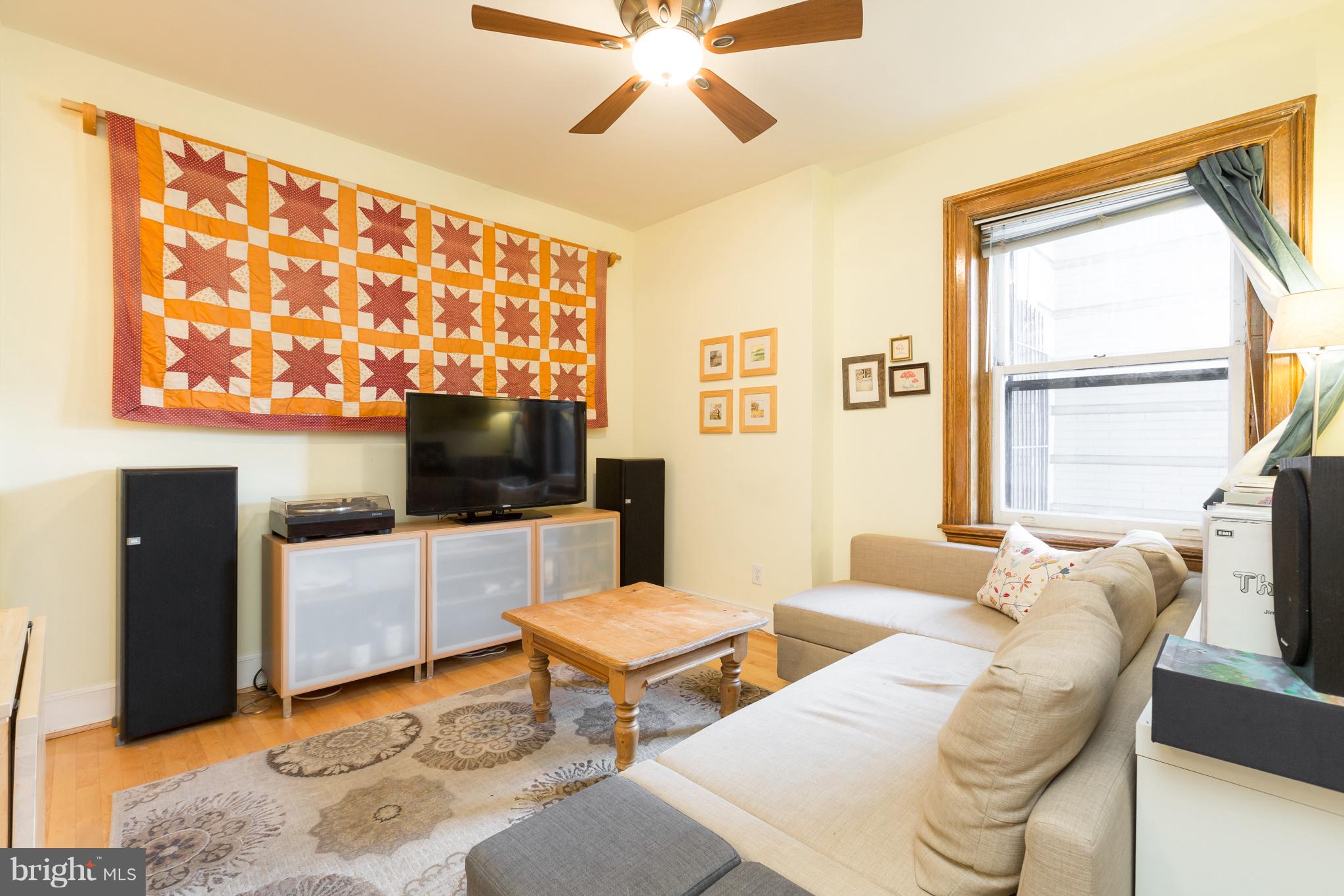 3060 16th Street Northwest, Unit 102 Washington, DC 20009 - Photo 4 of 17 a living room with furniture and a flat screen tv