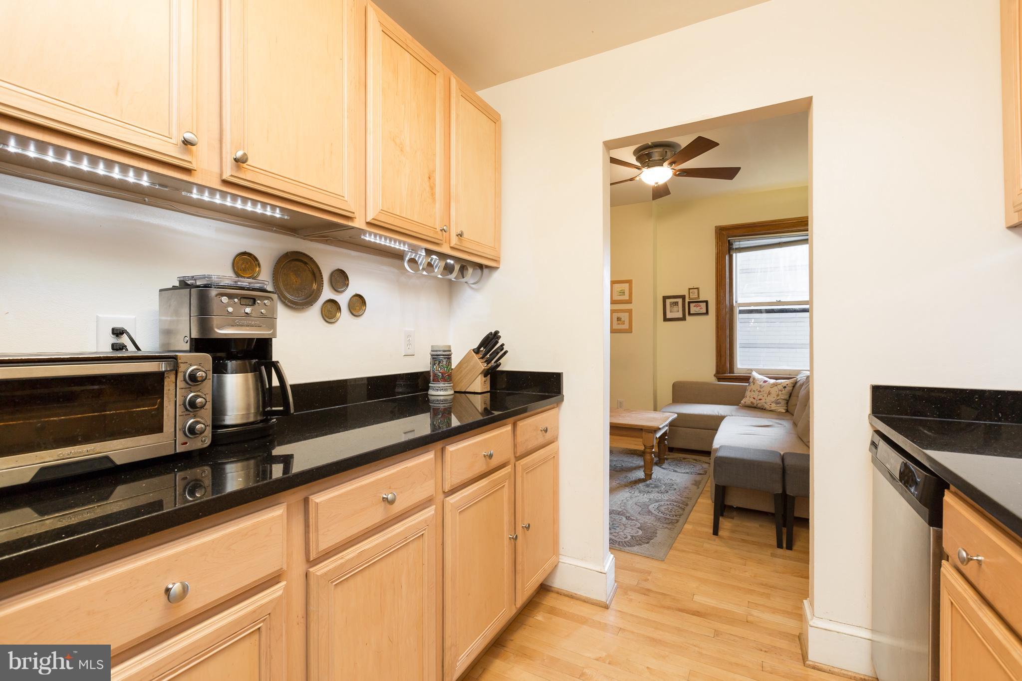 3060 16th Street Northwest, Unit 102 Washington, DC 20009 - Photo 6 of 17 a kitchen with stainless steel appliances granite countertop a sink and cabinets