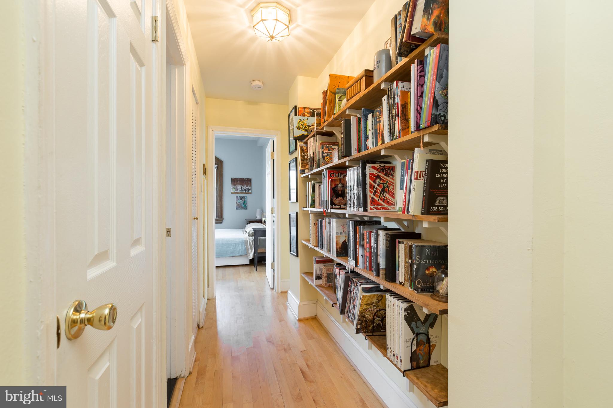 3060 16th Street Northwest, Unit 102 Washington, DC 20009 - Photo 7 of 17 a living room with lots of furniture and a book shelf