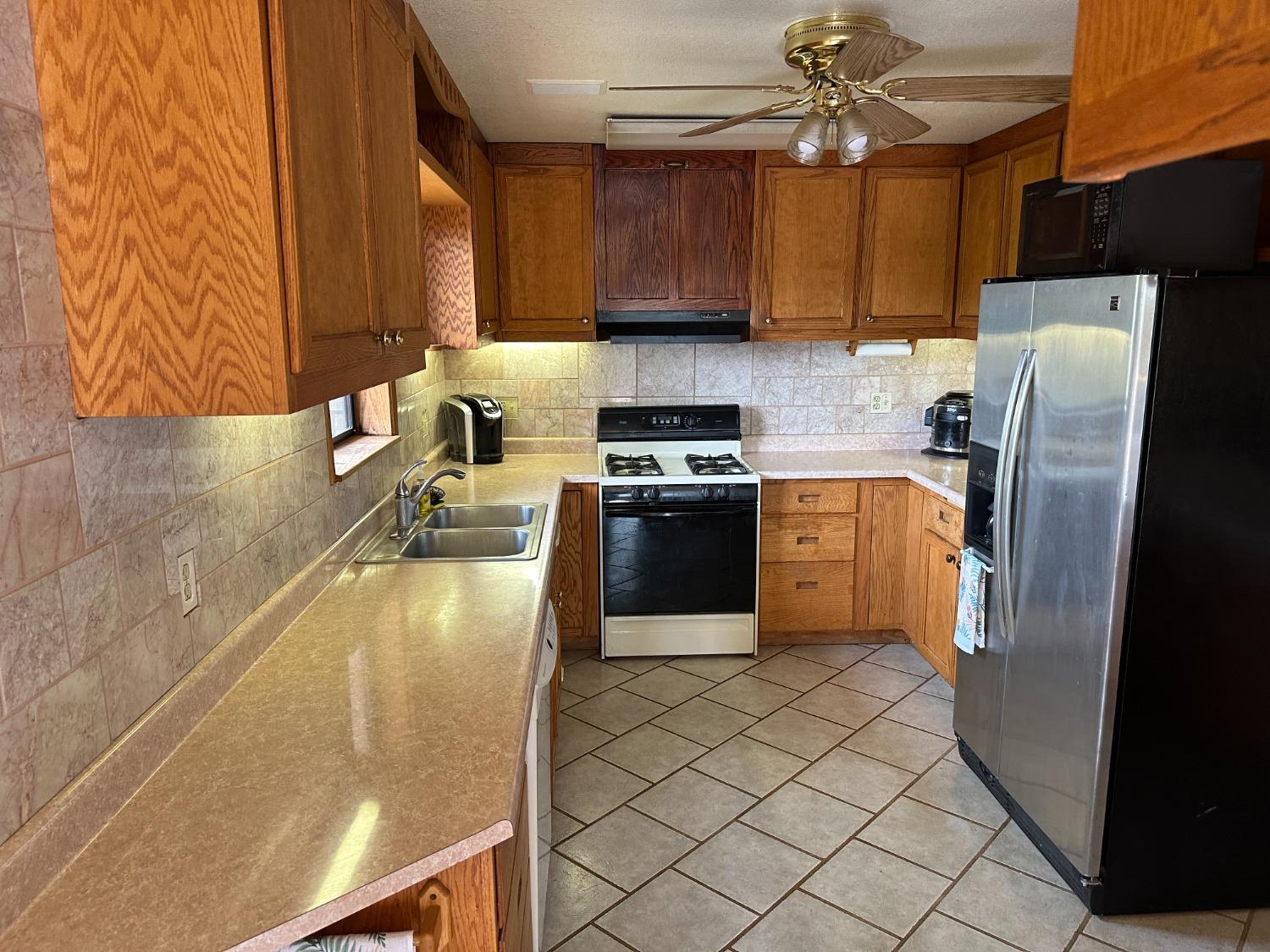 4368 Eazy Bird Road Wilseyville, CA 95257 - Photo 12 of 25 a kitchen with stainless steel appliances granite countertop a refrigerator a sink a stove top oven a washer and dryer