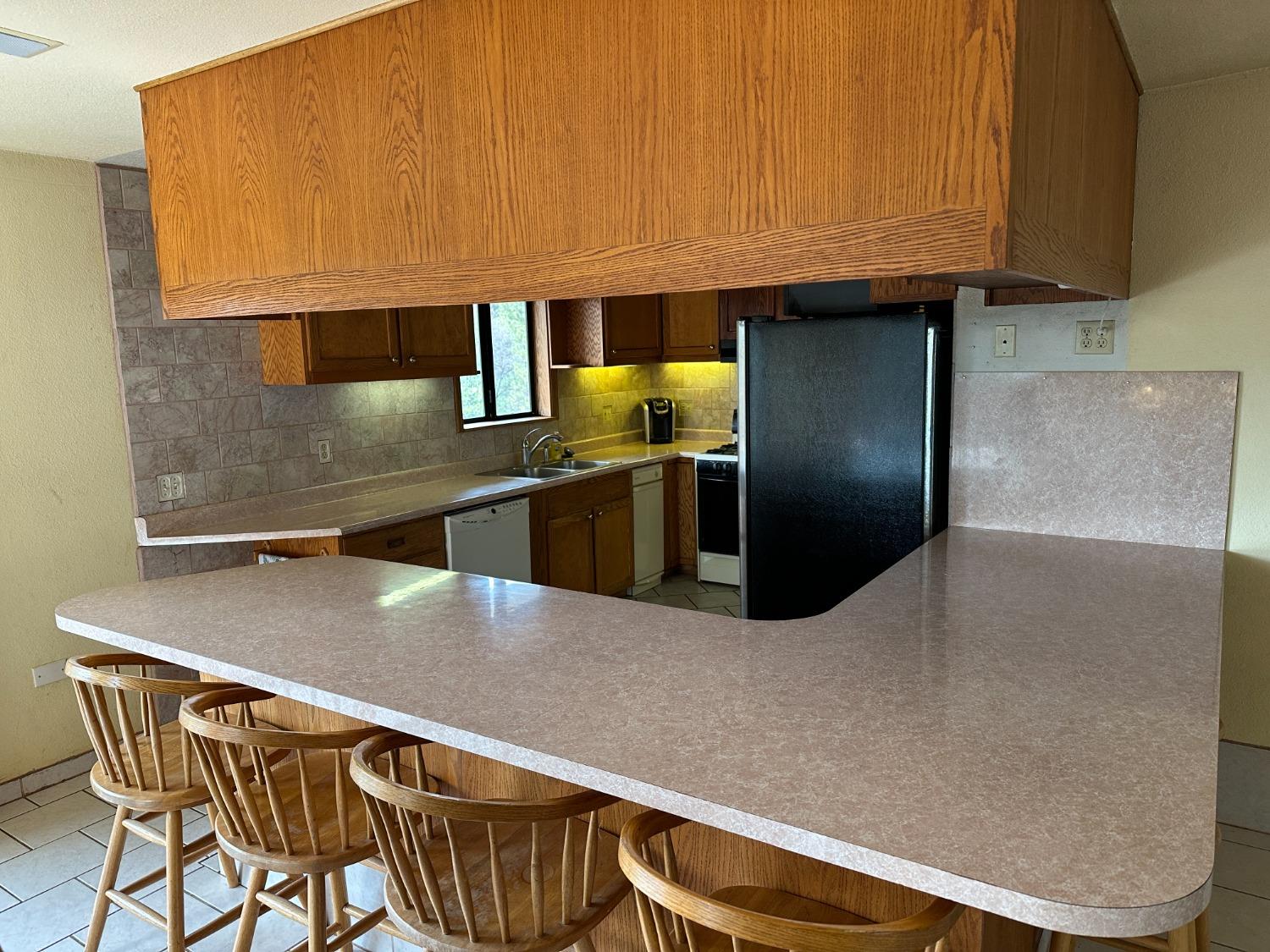 4368 Eazy Bird Road Wilseyville, CA 95257 - Photo 16 of 25 a kitchen with stainless steel appliances granite countertop a refrigerator a sink and a stove