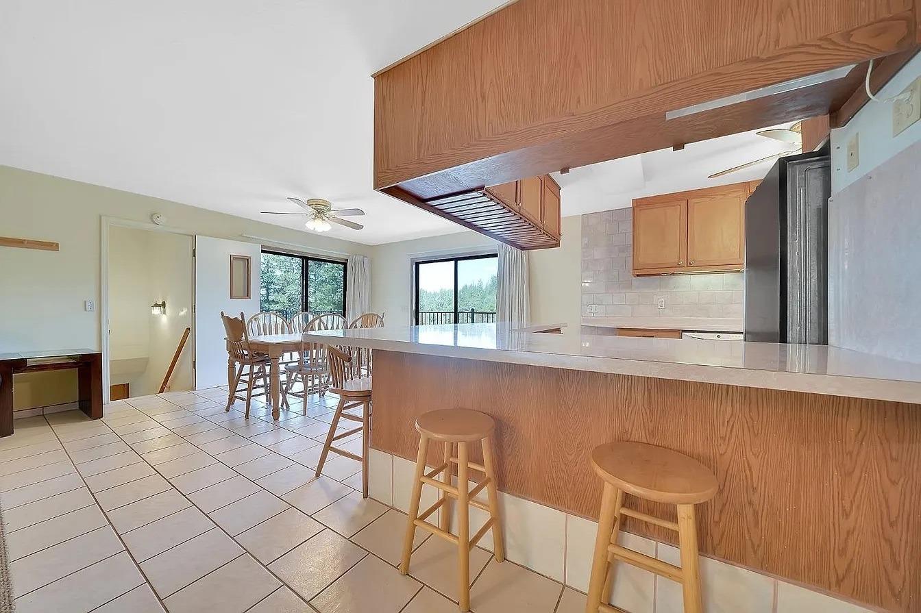 4368 Eazy Bird Road Wilseyville, CA 95257 - Photo 5 of 25 a dining room with furniture and a floor to ceiling window
