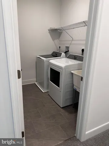 a white toilet sitting in a bathroom next to a sink